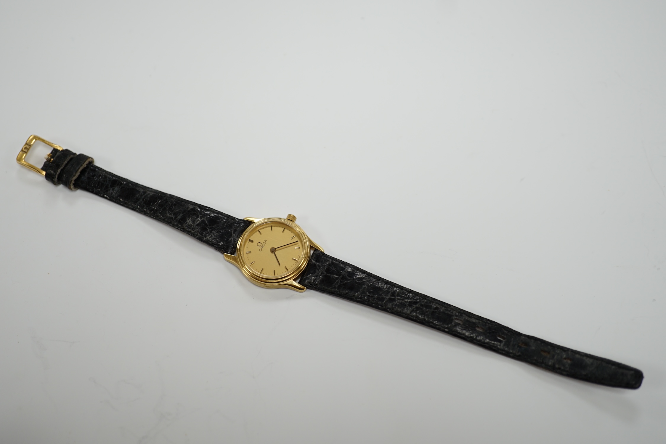 A lady's 18ct gold Omega quartz wrist watch, with case back inscription, on a leather strap with Omega buckle, with Omega box.